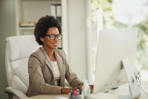 Black female professional at desk 