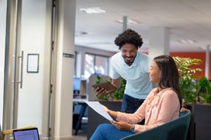 Smiling multiracial professionals discussing in office